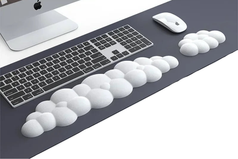 HandsCross ergonomic wrist rest desk pad with cloud-shaped cushioning placed on desk with keyboard and mouse