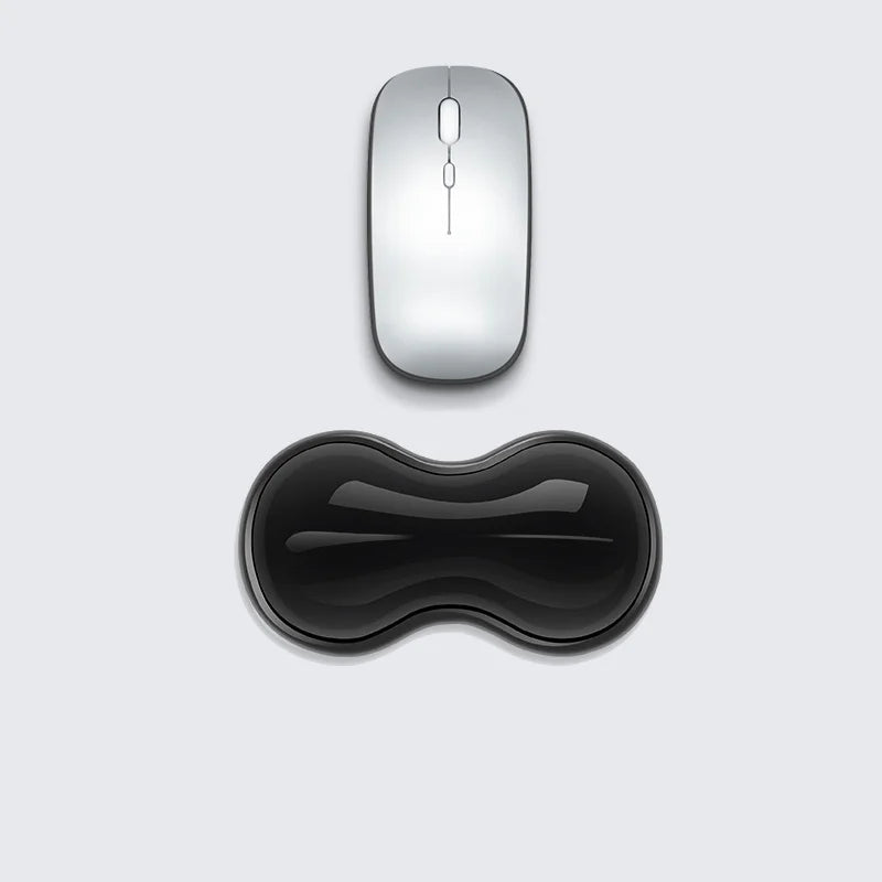 HandsCross ergonomic keyboard wrist rest in black with contoured shape below a silver wireless mouse