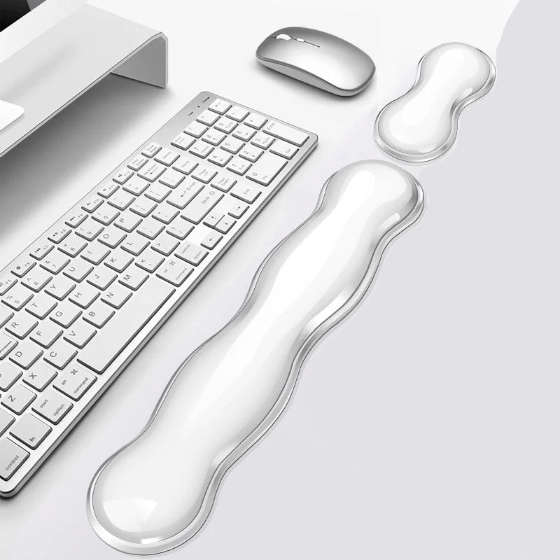 HandsCross ergonomic keyboard wrist rest in clear silicone with matching mouse pad on white desk