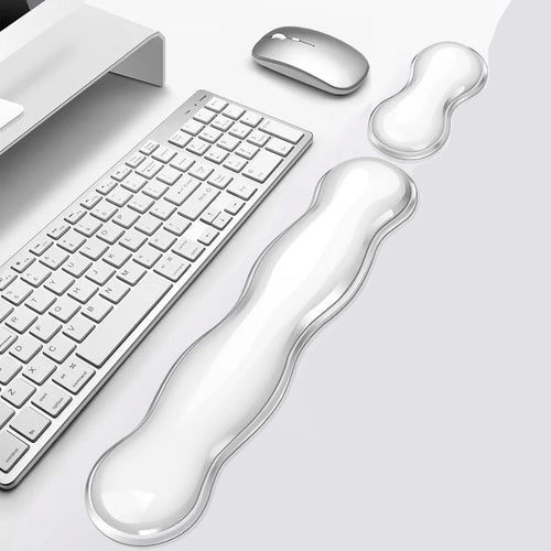 HandsCross ergonomic keyboard wrist rest in clear silicone with matching mouse pad on white desk